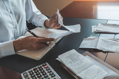 Midsection of man reading book on table