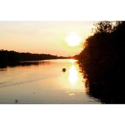 Scenic view of calm lake at sunset