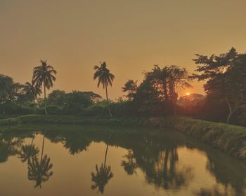 Scenic view of lake against sky during sunset