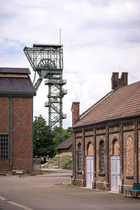 View of metallic structure against sky in city, lwl-industriemuseum zeche zollern
