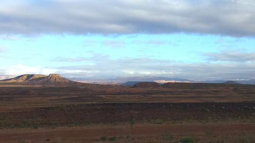 Scenic view of mountains against cloudy sky