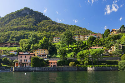 Lake como by town against mountain