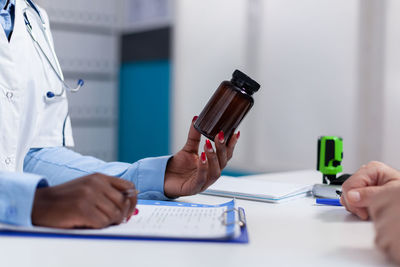 Midsection of man using mobile phone