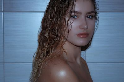 Close-up portrait of beautiful young woman at home