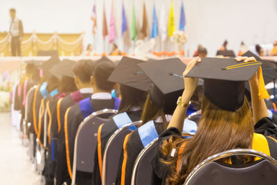 Rear view of students wearing graduation during ceremony