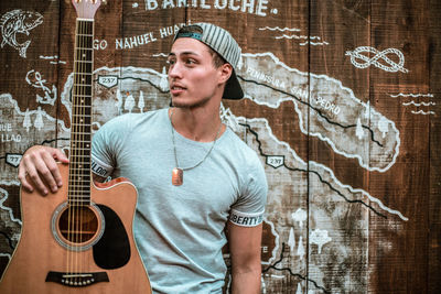 Portrait of young man playing guitar