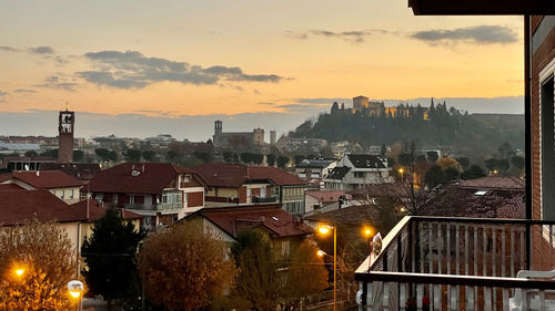 High angle view of illuminated buildings against sky at sunset