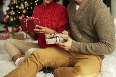 Midsection of couple holding hands