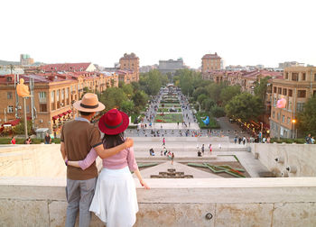 Rear view of couple standing on building terrace