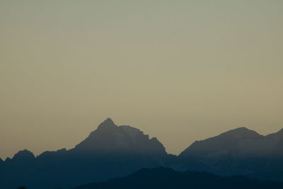 Silhouette mountain hill in the fog after a summer thunderstorm in the swiss alps