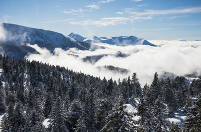 View of the belledonne massif in isère with clouds in the valley under the village of chamrousse