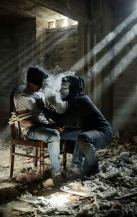 Man sitting in abandoned building