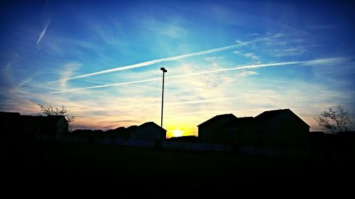 Low angle view of silhouette buildings against sky at sunset