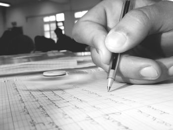 Close-up of hand writing on paper