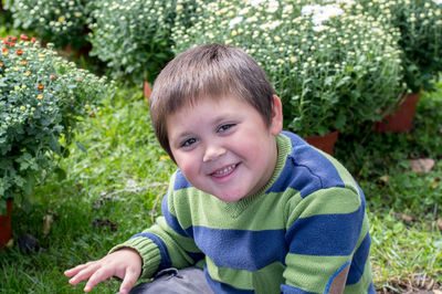 Cute little boy poses for a photo at a chrysanthemum farm