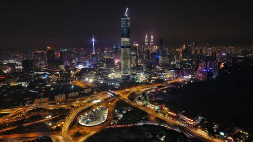 Aerial view of city lit up at night