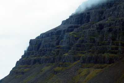 Low angle view of rock formation against sky