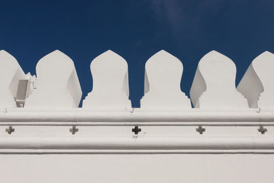 Low angle view of white building against blue sky