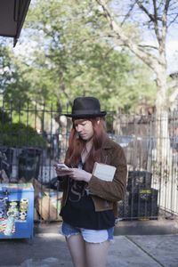 Young woman checking her smart phone