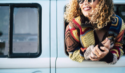 Woman leaning through camper van window