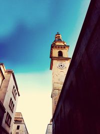 Low angle view of clock tower against sky in city