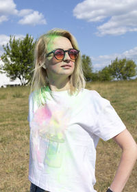 Portrait pretty blond woman with colored dye, powder on face and cloth on holi colors festival in