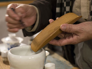 Close-up of man preparing oolong tea