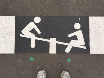 High angle view of arrow sign on road