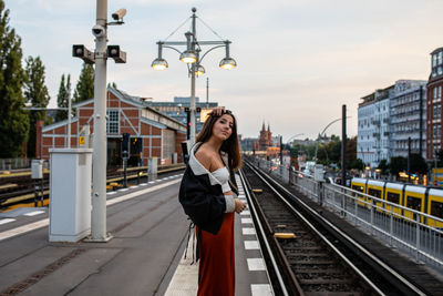 Side view of woman on railroad station platform