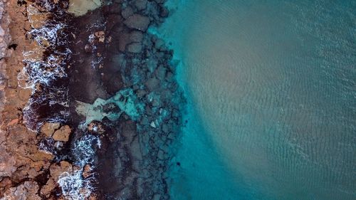 High angle view of rocks by sea