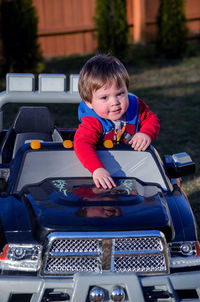 A young boy and his electric truck, offers a ride