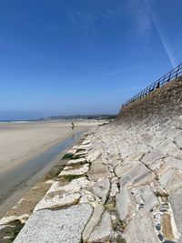 Scenic view of beach against blue sky