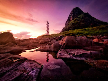 Rock formations against sky during sunset