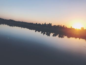 Scenic view of lake against sky during sunset