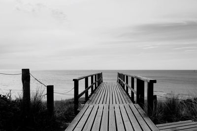Pier over sea against sky