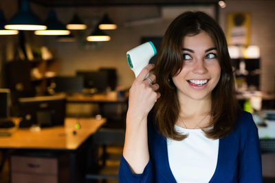 Portrait of young woman using mobile phone