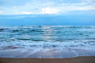 Scenic view of sea against cloudy sky