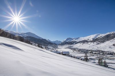 Scenic view of snowcapped mountains against clear blue sky