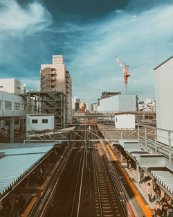 High angle view of railroad tracks amidst buildings in city