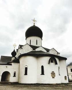 Low angle view of church against cloudy sky