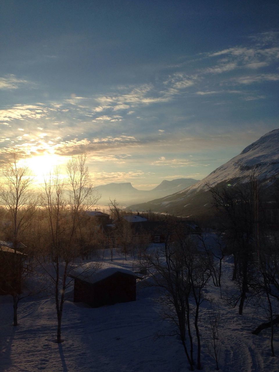 mountain, water, tranquil scene, sky, tranquility, scenics, sunset, lake, beauty in nature, sun, mountain range, snow, winter, nature, cold temperature, cloud - sky, tree, sunlight, river, reflection