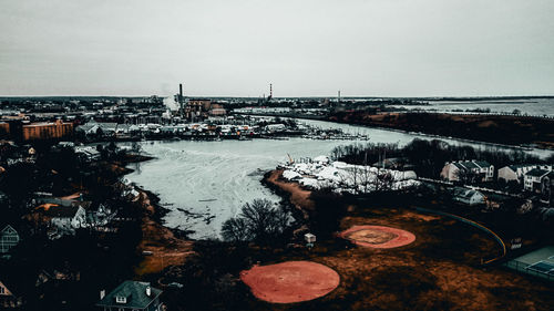 High angle view of buildings by sea during winter