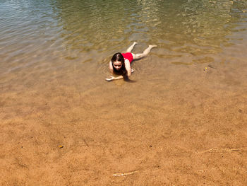 High angle view of woman lying on lake