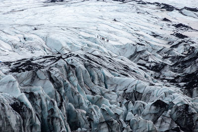 People hiking on the glacier of sólheimajökull