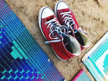 Low section of shoes on sand