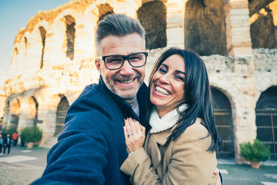 Portrait of smiling couple embracing outdoors