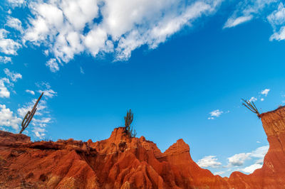 Low angle view of mountain against blue sky