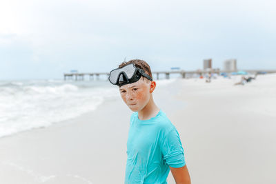 Boy standing on beach