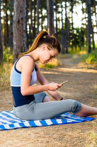 Woman sitting on mobile phone