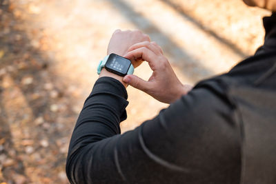 Girl checking smart watch with fitness tracker, looking at health data while exercising